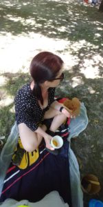 Carol eating noodles in the shade